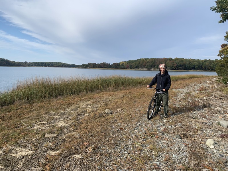 Rey with a bicycle on a path around a lake